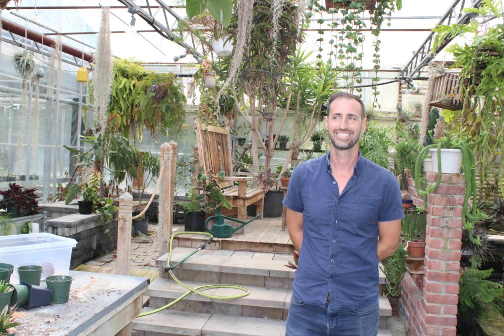 Man outside college greenhouse