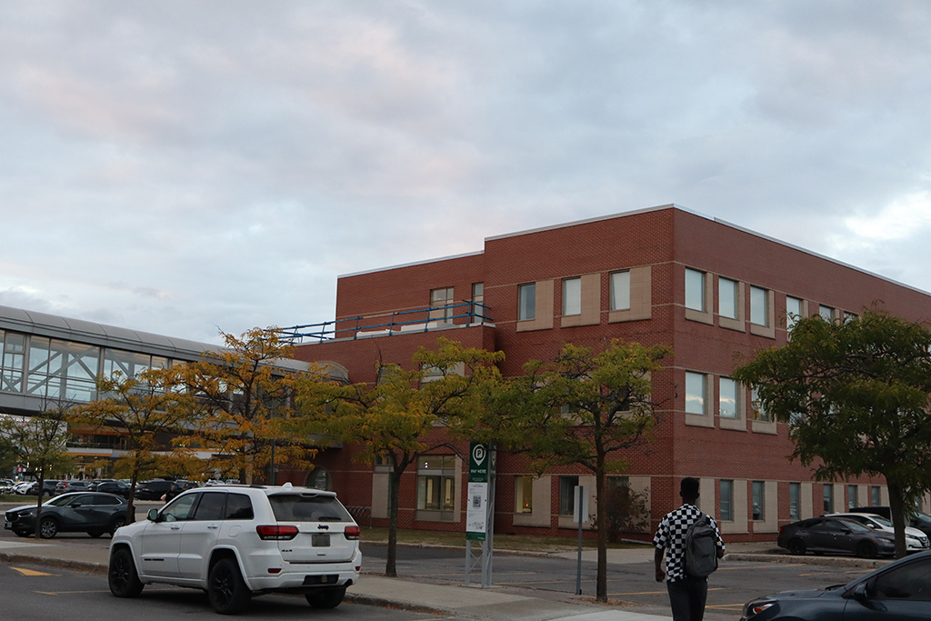 A student walking towards the P-building of Algonquin College