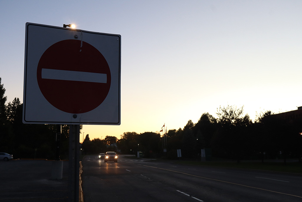 A do not enter sign with the sunset behind it
