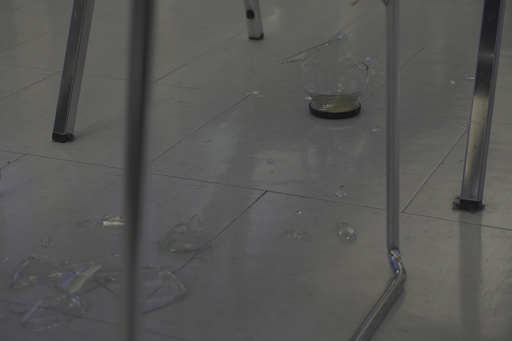 A shattered glass area was blocked off with two chairs for safety.